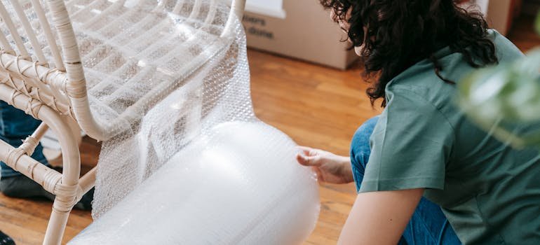 How to Pack Furniture When Moving to Cincinnati 4 a woman preparing furniture for moving