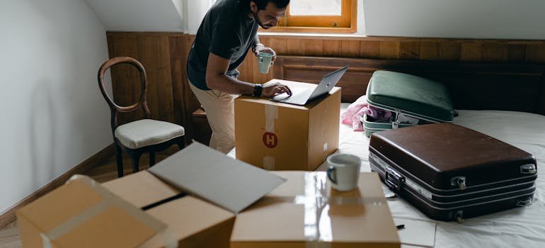 How to Downsize Your Belongings Before Moving to Cincinnati 1 a person using a laptop learning how to downsize for a move