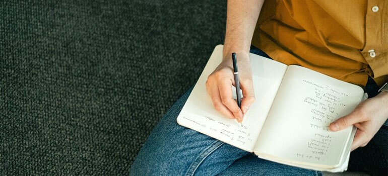 What's The Cost Of Living In Ohio? 3 A young an completing a moving checklist.