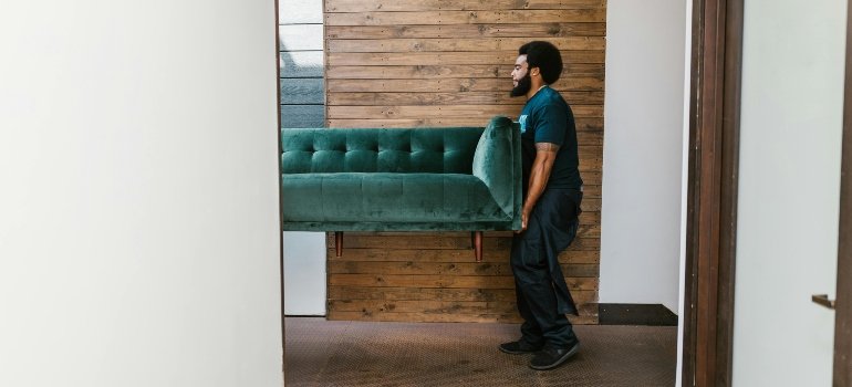 Is Lebanon Ohio a Nice Place to Live? 3 Professional movers handling bulky heavy furniture with care during a residential move.