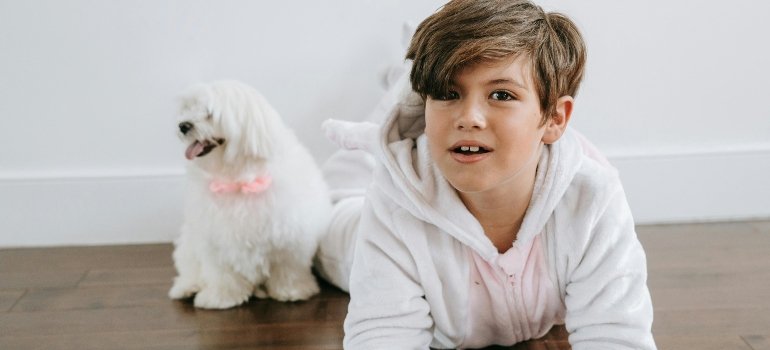 Why Are Families Moving To West Chester Ohio? 1 Boy in White Hoodie Sitting on Brown Wooden Floor while families moving