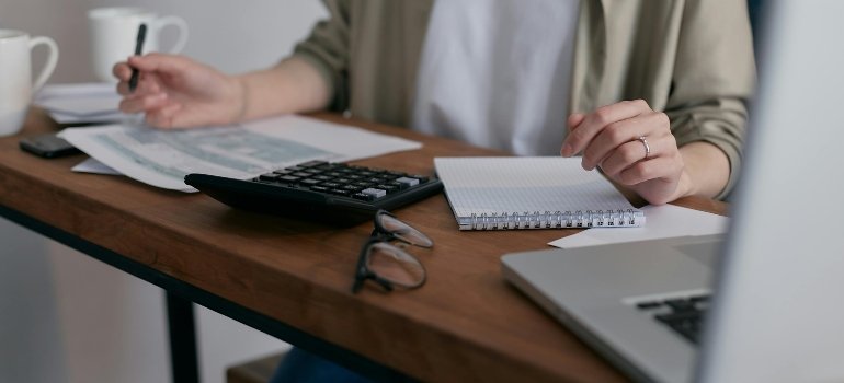 How To Plan A Long Distance Move To Cincinnati 3 A woman making a checklist