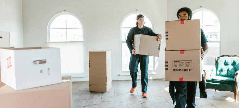 Moving With Kids To Loveland Ohio: What to Expect 2 Men Carrying Boxes Inside the House