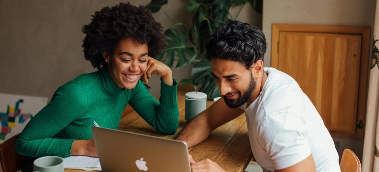 How To Make Moving Less Stressful 2 Photo of a Man and Woman Looking at the Screen of a Laptop