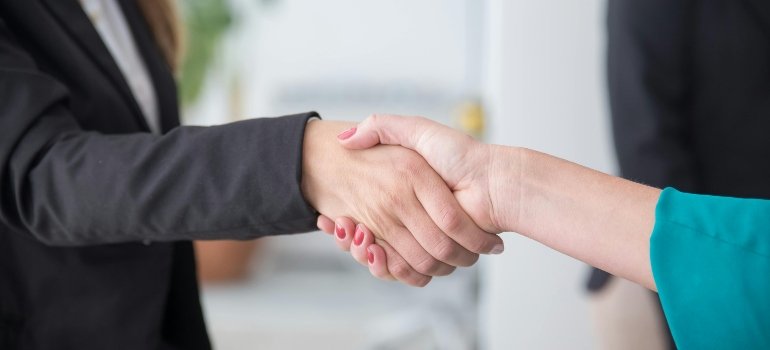 What’s The Average Cost Of Moving To Another State? 3 a handshake between a man and a woman