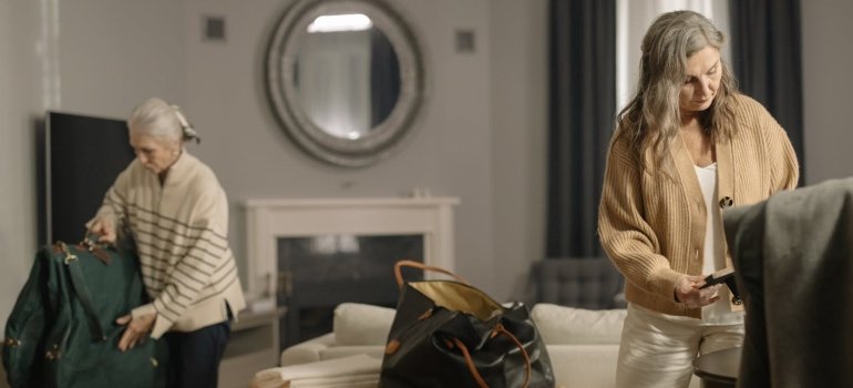 Tips for Moving to a Senior Living Cincinnati Ohio Facility 4 Two women in a cozy living room are packing bags