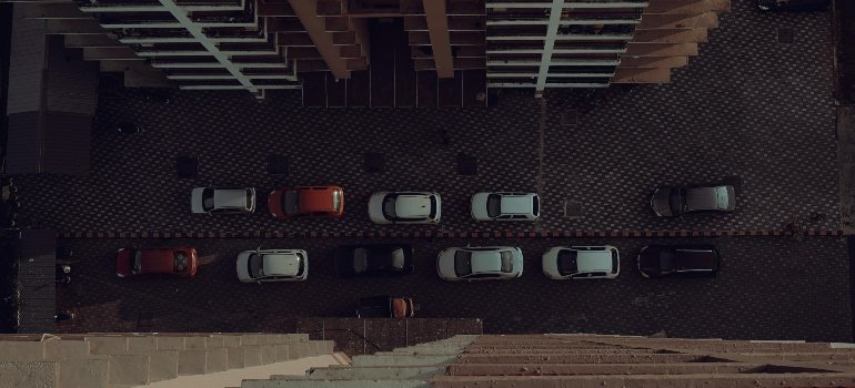 Is Cincinnati A Good Place To Live? 3 Aerial view of a parking lot with neatly arranged cars, surrounded by a modern building's facade