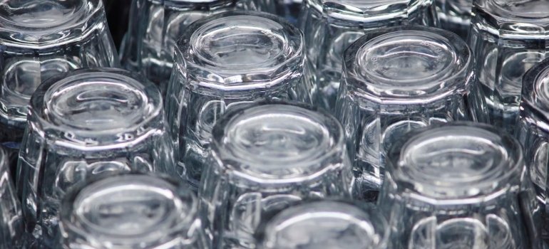 How To Pack Glassware For Moving 3 A neatly arranged collection of clear glass cups turned upside down, tips on how to pack glassware for moving