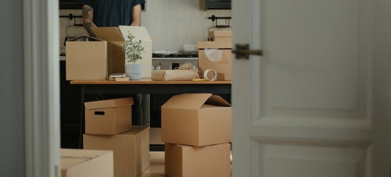Smart Moving Hacks That Save Time and Stress 4 a man unpacking after following moving tips and hacks