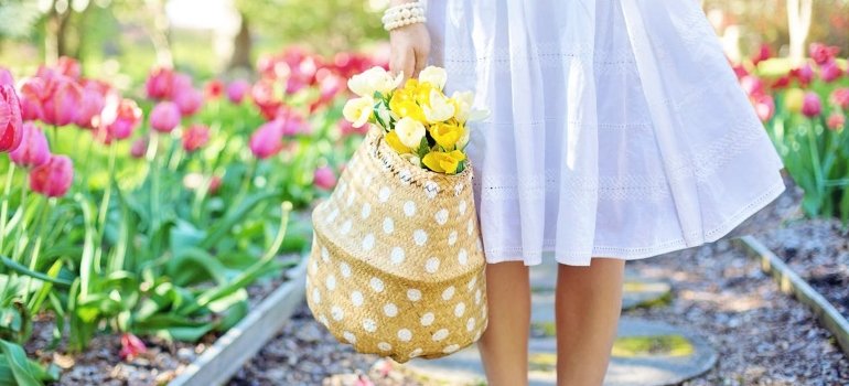 Best Getaways in Ohio for Every Season 1 a woman in a white dress surrounded by flowers during spring weekend vacations in Ohio