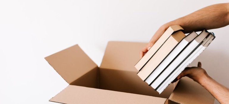Smart Moving Hacks That Save Time and Stress 2 a man following moving hacks to pack books