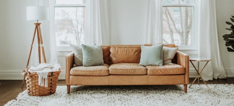 How To Clean An Apartment Before Moving In 2 A clean couch, emphasizing on How to clean a house before moving in, with cleaning supplies ready for apartment and house move-ins