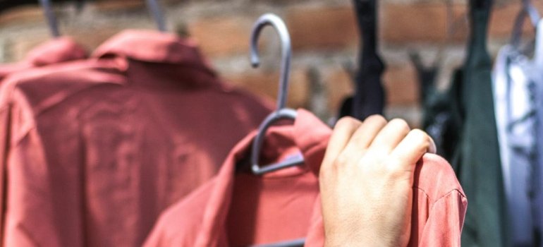 How to Pack Clothes for Moving Like a Pro 1 a person preparing and packing clothes for moving