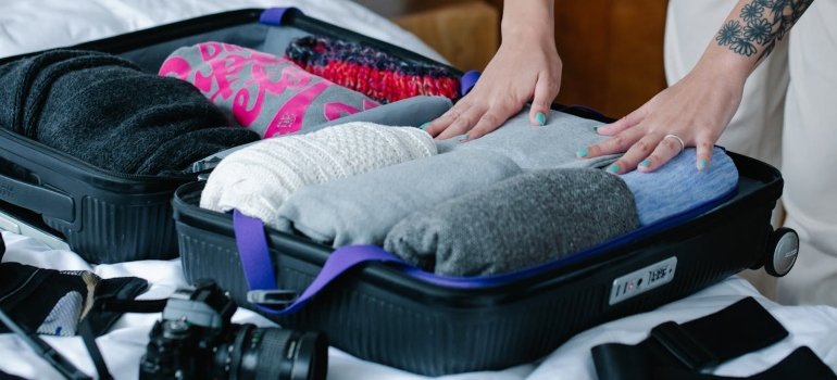 How to Pack Clothes for Moving Like a Pro 2 a woman figuring out the best way to move clothes