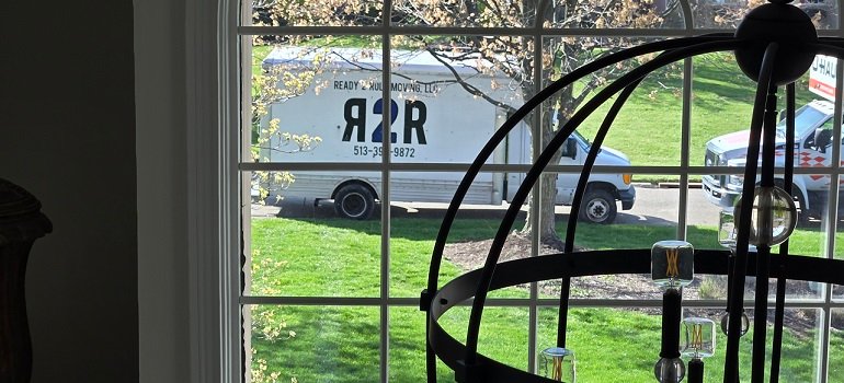 Hamilton Movers 4 R2R moving truck outside home window during move