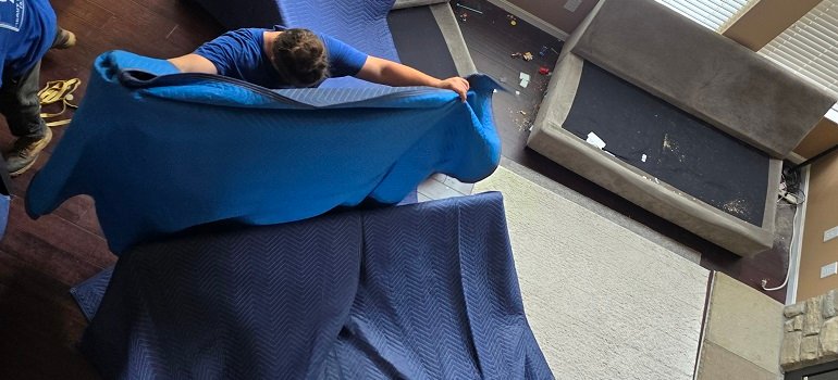 How to Move Your Office Across State Lines Without Interrupting Business 1 Employee packing office supplies to move your office across state lines