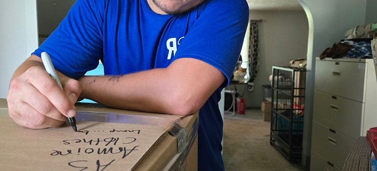 How to Move with Medical Equipment: Tips for Patients and Caregivers 1 Worker labeling boxes for a careful move with medical equipment