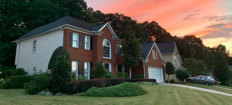 A Local’s Guide to the Best Suburbs of Cincinnati Ohio 3 Beautiful brick suburban homes at sunset showing the kind of peaceful neighborhoods found in the best suburbs of Cincinnati Ohio.