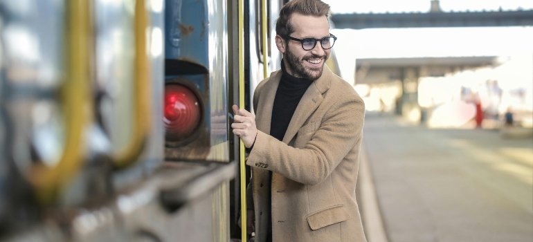 A Local’s Guide to the Best Suburbs of Cincinnati Ohio 4 Man smiling while stepping onto a train at a station.