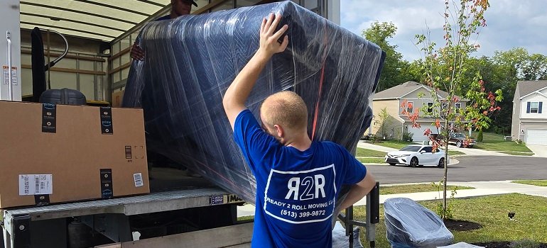 Morrow Movers 4 one of the morrow movers loading a heavy piece of furniture into the moving truck