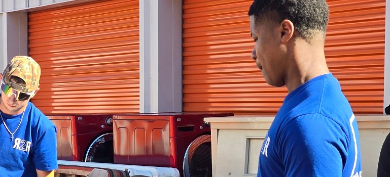 Harrison Movers 4 two professional movers loading a moving van.