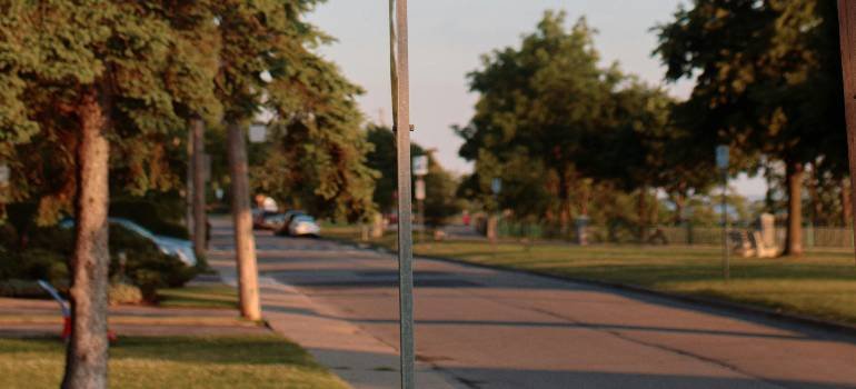 Actionable relocation guide to Hamilton Ohio 1 Quiet Hamilton residential street with trees and parked cars