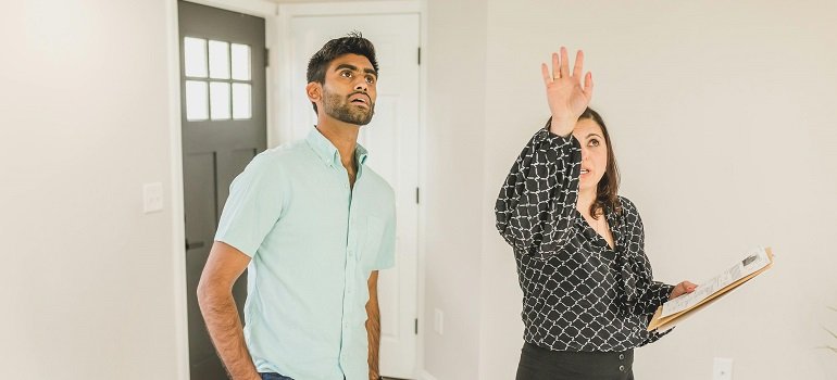 An essential checklist for homebuyers in Loveland OH 2 Agent pointing out ceiling details to homebuyers in Loveland OH