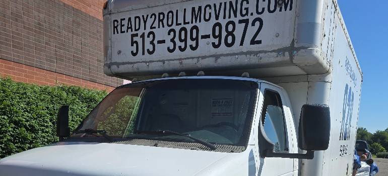 A comprehensive guide for families moving to Hamilton OH 6 Ready2Roll moving truck parked beside brick building