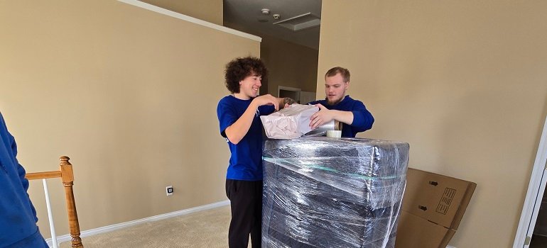 3 incredible ways to save money when moving 3 movers packing an item