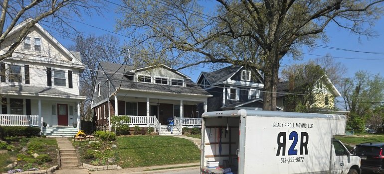 Benefits of living in Cincinnati suburbs 1 Moving truck parked outside classic Cincinnati suburban homes