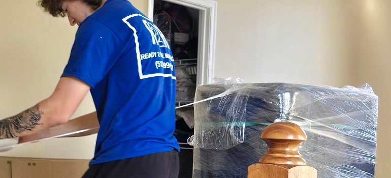 How to efficiently pack for your move 3 Mover wrapping protected furniture with plastic film