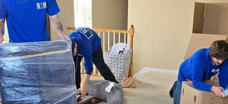 Tackling hoarding before a move 2 professionals sorting hoarding before a move in crowded living space