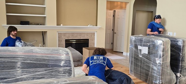 Maximizing daylight during your February move: Tips for a smooth transition 5 Moving crew wrapping furniture with protective plastic