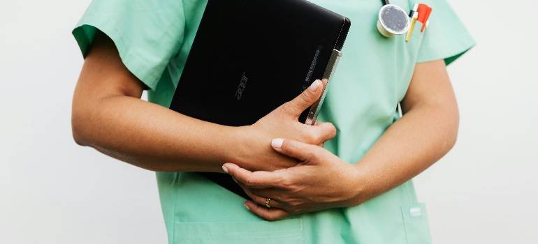 Benefits of living in Cincinnati suburbs 6 Nurse holding tablet, ready for suburban clinic shift