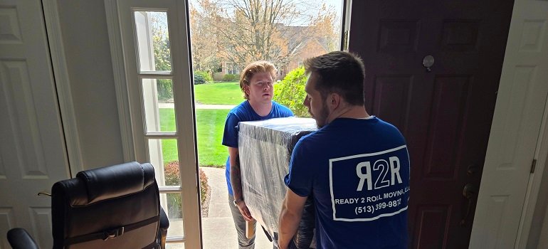 Helpful guide for a successful relocation to West Chester OH 5 Movers carry protected cabinet during relocation to West Chester OH