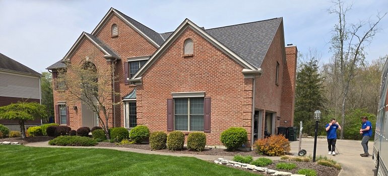 Helpful guide for a successful relocation to West Chester OH 3 Spacious brick house with movers preparing front yard