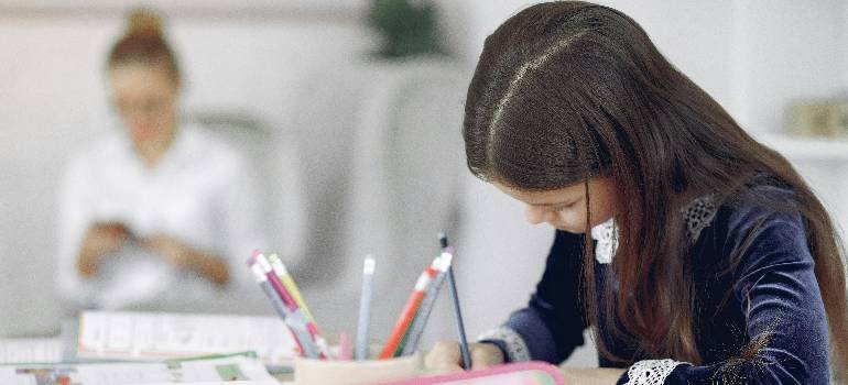 Moving during the school year in Cincinnati: Checklist for parents 8 Girl studying at desk in new classroom