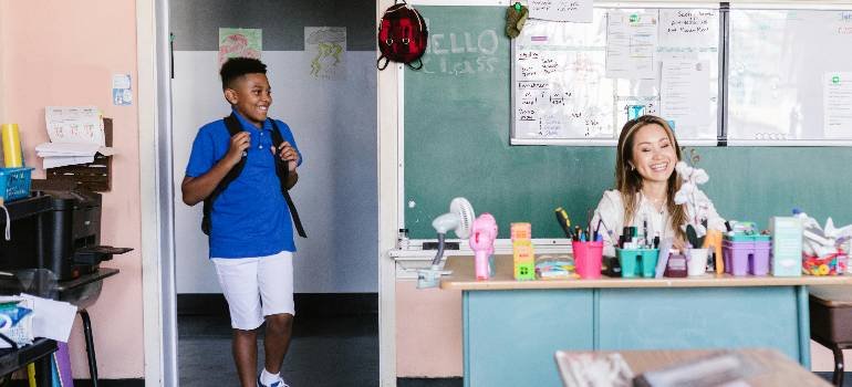 Moving during the school year in Cincinnati: Checklist for parents 3 Student arriving late smiling at friendly teacher